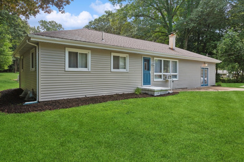 This charming and well-maintained home is set on a spacious - Beach Home for sale in Coloma, Michigan on Beachhouse.com