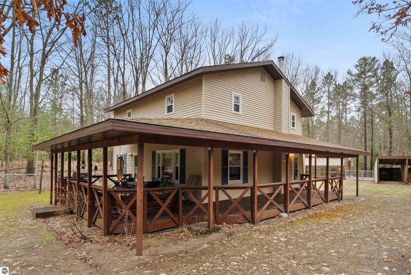Set on a private wooded lot, this property offers a fenced yard - Beach Home for sale in Traverse City, Michigan on Beachhouse.com