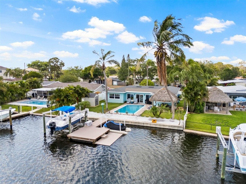 This TROPICAL OASIS is calling you! Your WATERFRONT POOL home is - Beach Home for sale in St. Petersburg, Florida on Beachhouse.com