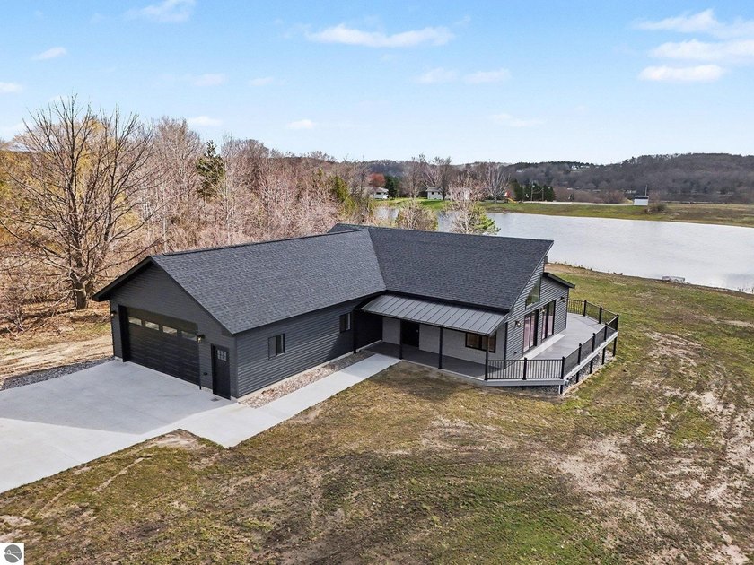 Nestled on a quiet inland pond- this stunning new-construction - Beach Home for sale in Ellsworth, Michigan on Beachhouse.com