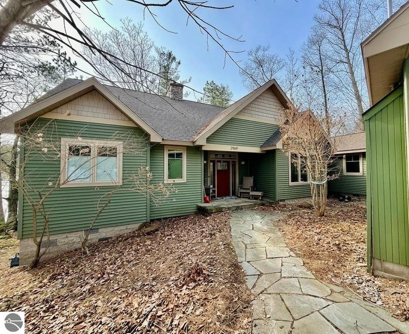 Set on 140 feet of private frontage along Mickey Lake--with - Beach Home for sale in Traverse City, Michigan on Beachhouse.com