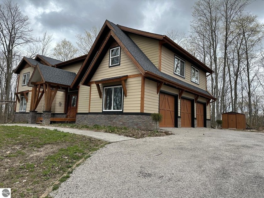 Perched atop a scenic hill in desirable Long Lake Township, this - Beach Home for sale in Traverse City, Michigan on Beachhouse.com