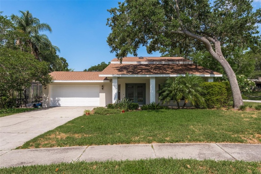 Nestled on a serene 1-acre lot, this charming property offers - Beach Home for sale in Palm Harbor, Florida on Beachhouse.com