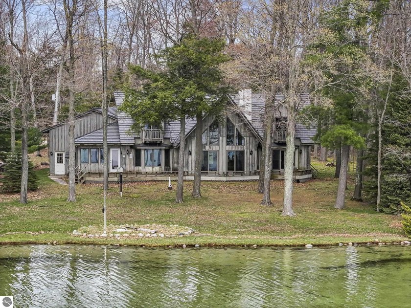 Welcome to a rare opportunity on Little Traverse Lake. Available - Beach Home for sale in Maple City, Michigan on Beachhouse.com