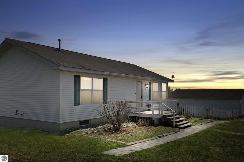 This inviting 3-bedroom, 2-bathroom home offers the perfect - Beach Home for sale in Kewadin, Michigan on Beachhouse.com