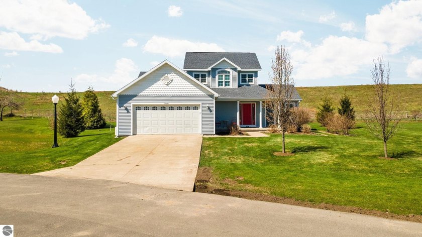 Tucked at the end of a quiet cul-de-sac on a spacious double lot - Beach Home for sale in Charlevoix, Michigan on Beachhouse.com