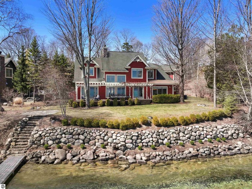 Set along the iconic crystal-blue shoreline of Torch Lake, this - Beach Home for sale in Kewadin, Michigan on Beachhouse.com