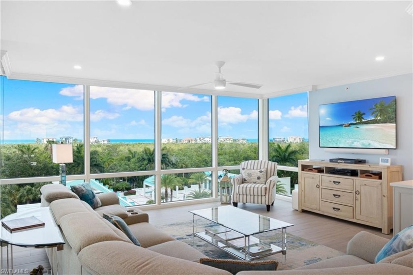 This lovely renovated residence wraps around the SW corner of - Beach Home for sale in Naples, Florida on Beachhouse.com