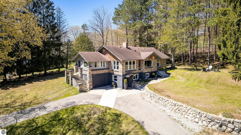 Discover this iconic and historic 4-bedroom, 3-bath home tucked - Beach Home for sale in Frankfort, Michigan on Beachhouse.com