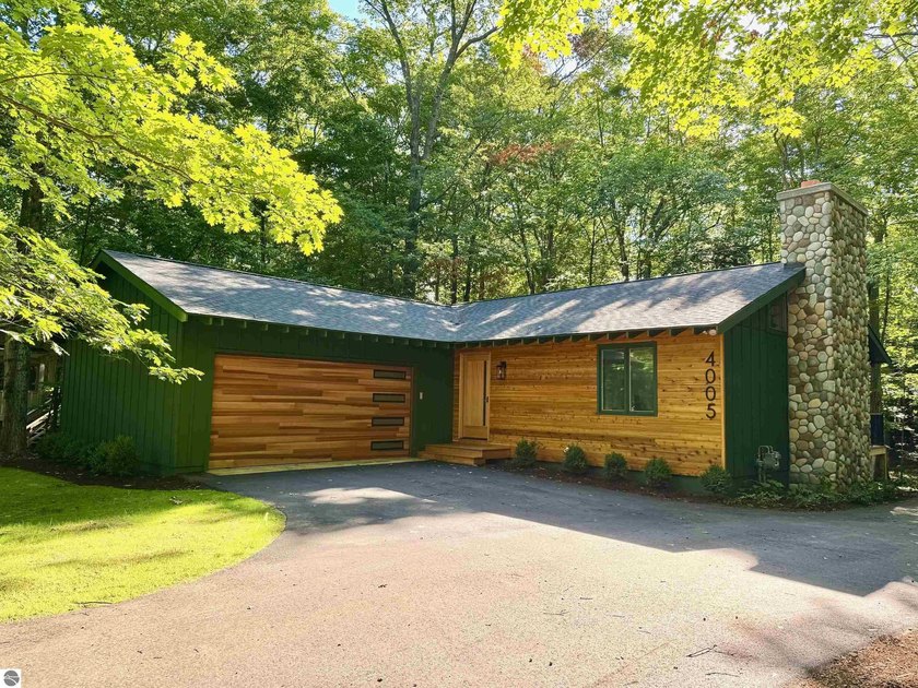 This beautifully remodeled home offers modern comfort and - Beach Home for sale in Leland, Michigan on Beachhouse.com