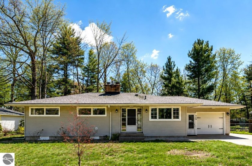 Located on a spacious city lot along a quiet, tree-lined street - Beach Home for sale in Traverse City, Michigan on Beachhouse.com