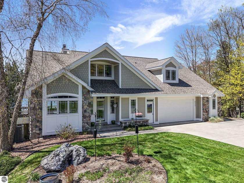 Perched along one of the most coveted stretches at the base of - Beach Home for sale in Traverse City, Michigan on Beachhouse.com
