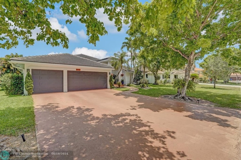 This immaculately maintained home boasts a 3-car garage, a 2019 - Beach Home for sale in Coral Springs, Florida on Beachhouse.com
