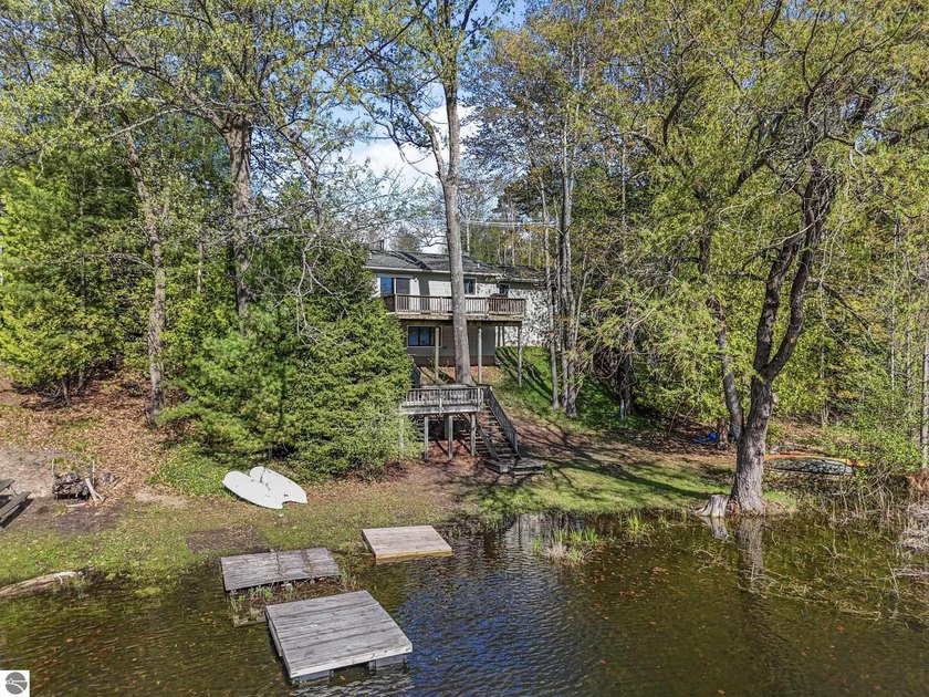 Nestled in a peaceful corner of Spider Lake, this four-bedroom - Beach Home for sale in Traverse City, Michigan on Beachhouse.com