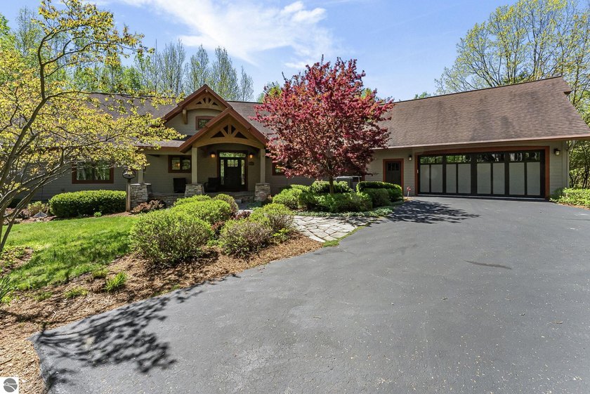 Tucked away on 29 beautiful private wooded acres, this - Beach Home for sale in Onekama, Michigan on Beachhouse.com