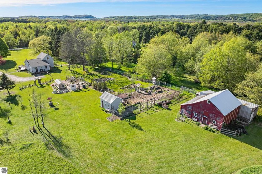 Tucked among rolling meadows, gardens, and wooded trails, this - Beach Home for sale in Frankfort, Michigan on Beachhouse.com