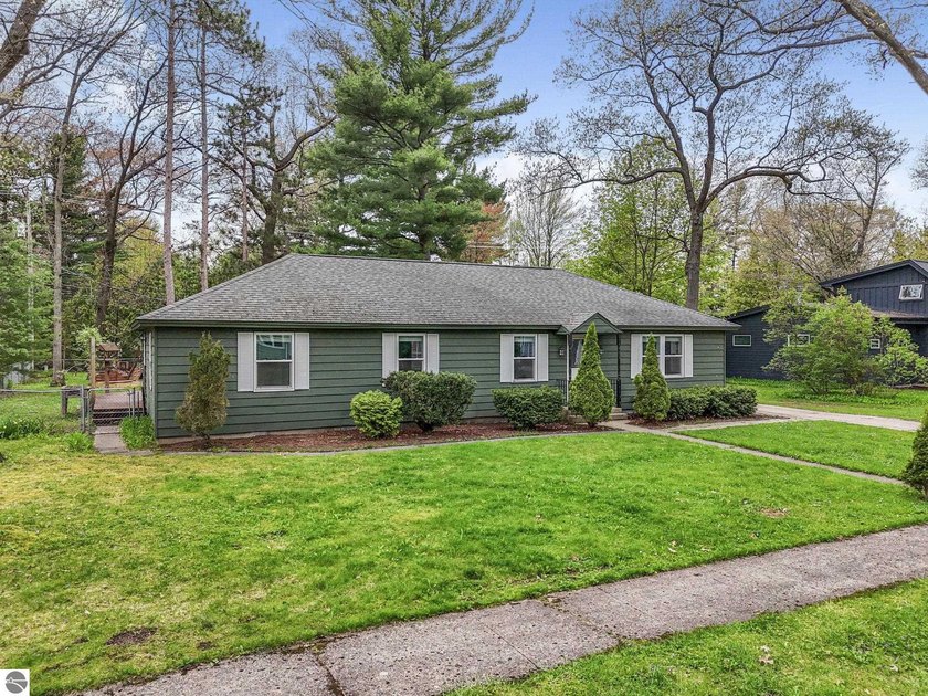 Nestled in a quiet neighborhood in Traverse City, this charming - Beach Home for sale in Traverse City, Michigan on Beachhouse.com