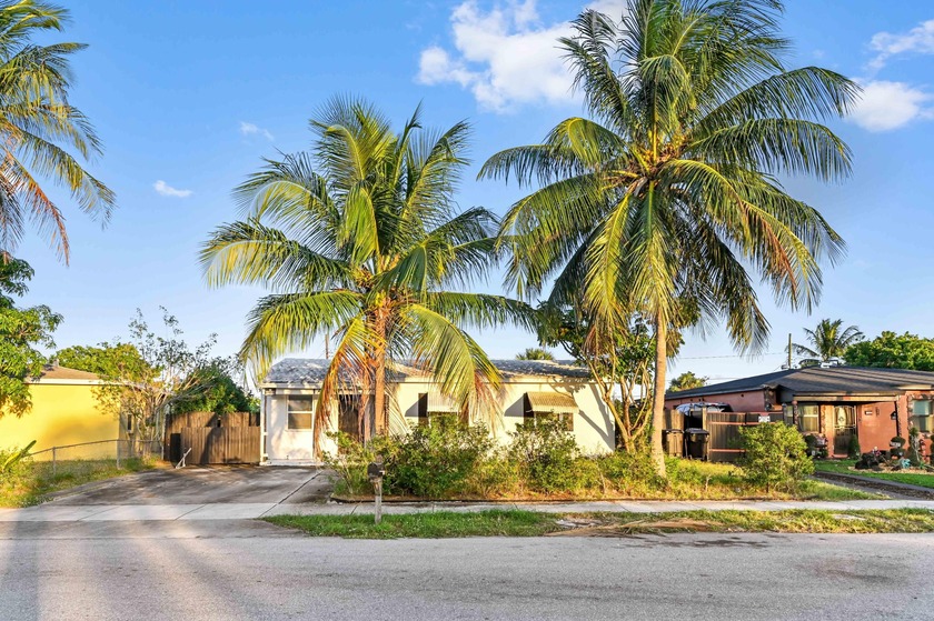 Welcome to this charming 1-story home in Whispering Palms on a - Beach Home for sale in Lake Worth Beach, Florida on Beachhouse.com