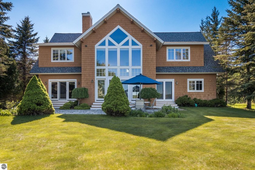 Experience luxury waterfront living on the crystal-clear shores - Beach Home for sale in Kewadin, Michigan on Beachhouse.com