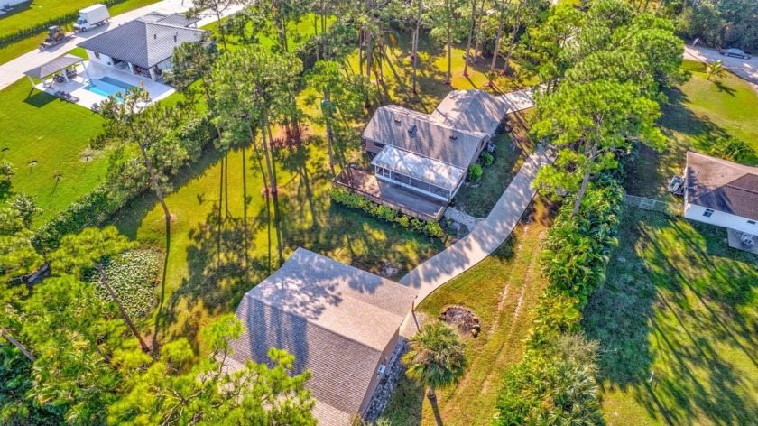 Nestled in the sought-after eastern area of the Acreage, this - Beach Home for sale in West Palm Beach, Florida on Beachhouse.com