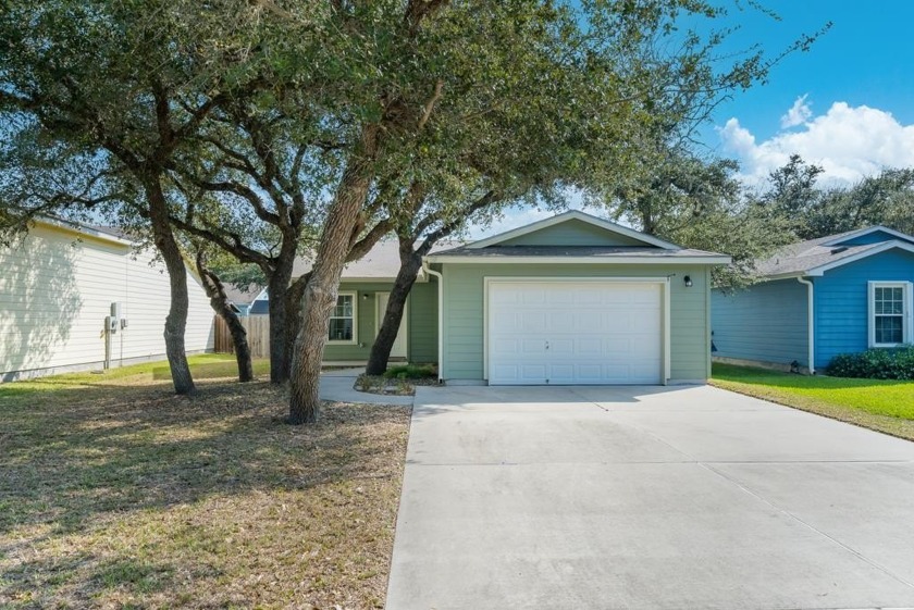 Nestled beneath 6 mature live oaks, this 2-bedroom, 2-bath home - Beach Home for sale in Rockport, Texas on Beachhouse.com