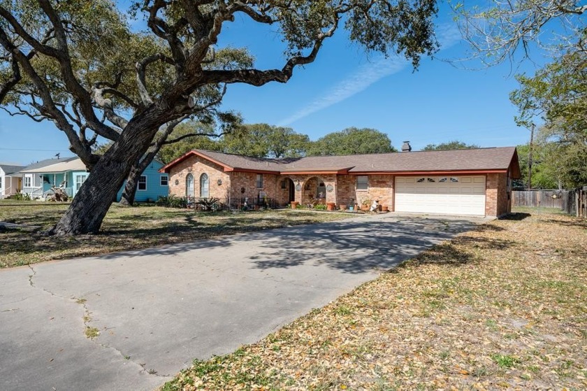 Nestled beneath the shade of sprawling oak trees on over three - Beach Home for sale in Aransas Pass, Texas on Beachhouse.com