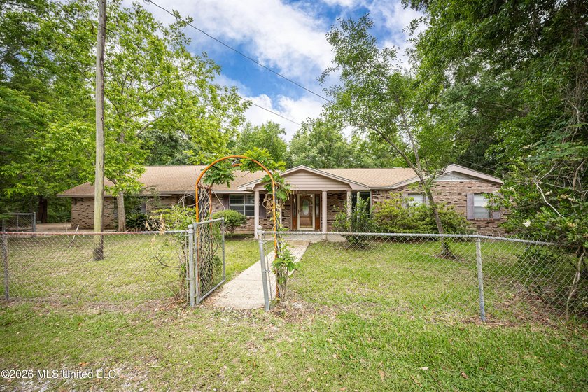 Discover a beautifully maintained 1962 home on nearly one acre-a - Beach Home for sale in Ocean Springs, Mississippi on Beachhouse.com