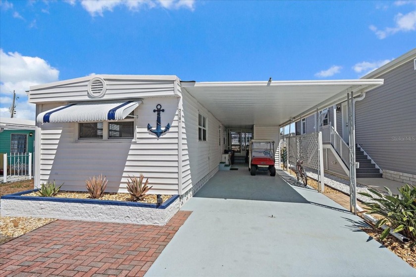 Welcome to this LAID-BACK COASTAL GEM in TROPIC ISLES, a vibrant - Beach Home for sale in Palmetto, Florida on Beachhouse.com