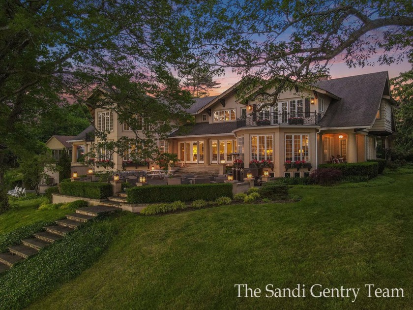 WITH OVER 400' OF PRIME SPRING LAKE WATER FRONTAGE SITS THIS - Beach Home for sale in Spring Lake, Michigan on Beachhouse.com