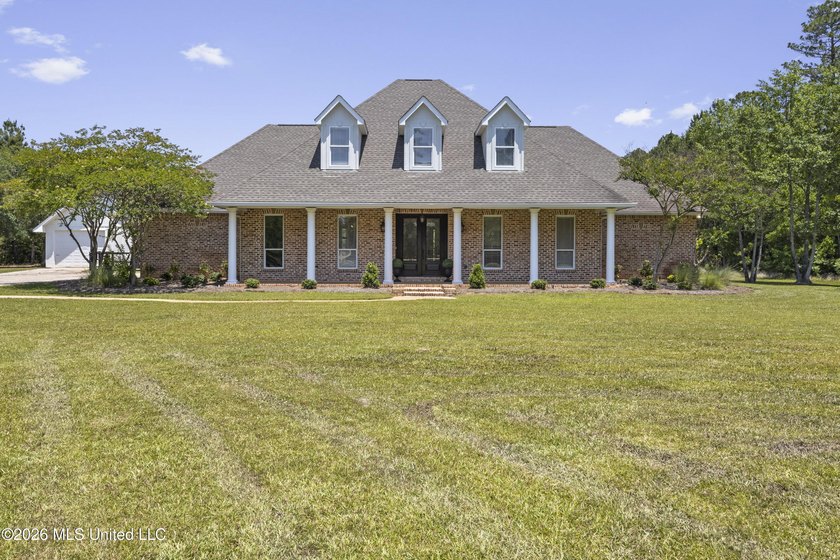 Tucked behind a gated entrance on 5 private acres, this - Beach Home for sale in Pass Christian, Mississippi on Beachhouse.com