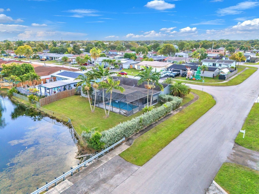 Charming 4-bedroom, 2-bath corner-lot lakefront home featuring a - Beach Home for sale in Sunrise, Florida on Beachhouse.com