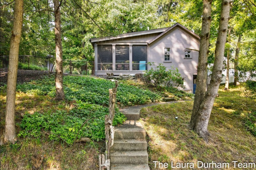 Tucked away in a serene wooded setting off Ferry St, this - Beach Home for sale in Douglas, Michigan on Beachhouse.com