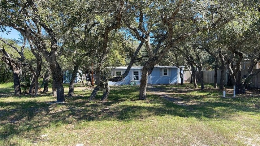 Tucked away and surrounded by beautiful mature trees is this - Beach Home for sale in Rockport, Texas on Beachhouse.com