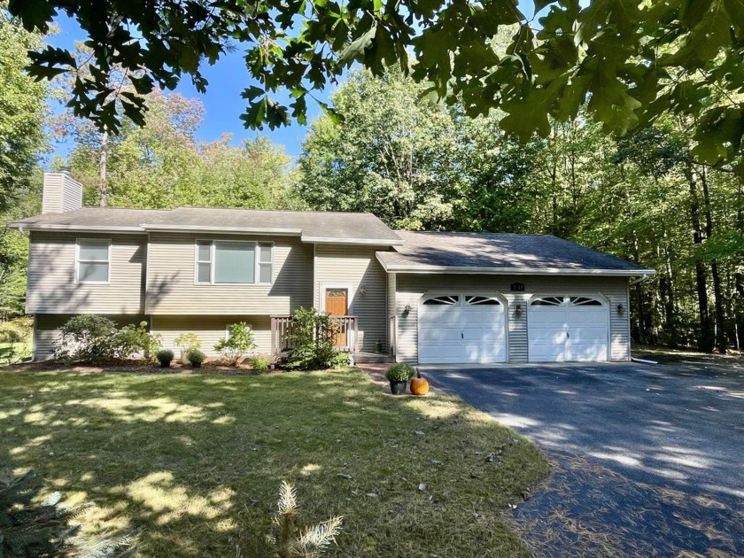 Nestled on a serene and heavily wooded 10-acre lot, this - Beach Home for sale in Ludington, Michigan on Beachhouse.com