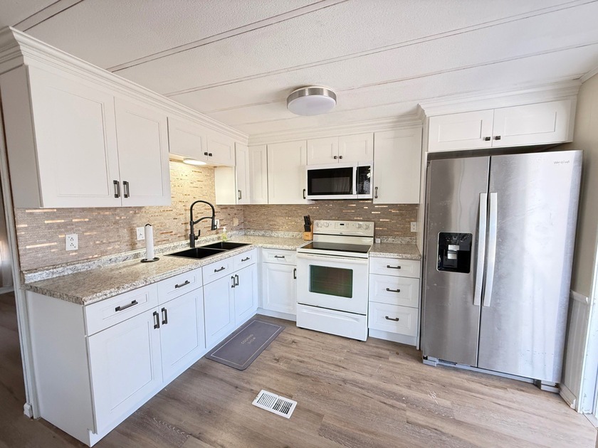 Located in Old Bridge Village, a vibrant, gated, 55+ boating - Beach Home for sale in North Fort Myers, Florida on Beachhouse.com