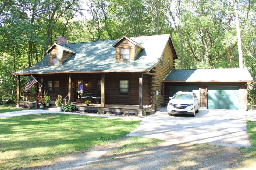 Introducing this cozy and well maintained 3-bedroom 2+bath log - Beach Home for sale in Muskegon, Michigan on Beachhouse.com