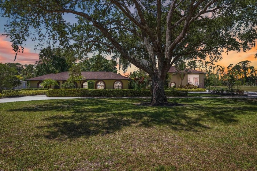 Tucked behind a gated entry and surrounded by mature trees, this - Beach Home for sale in North Port, Florida on Beachhouse.com