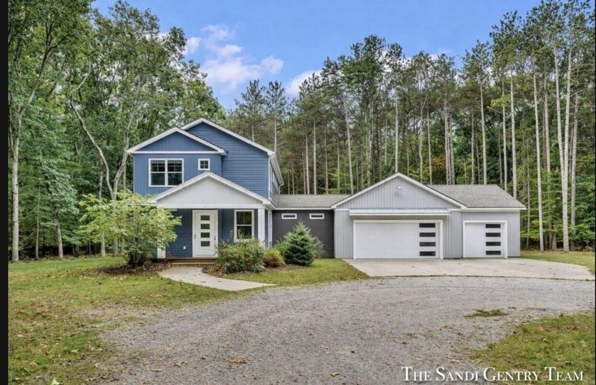 Nestled on over 10 scenic wooded acres, this stunning - Beach Home for sale in Grand Haven, Michigan on Beachhouse.com