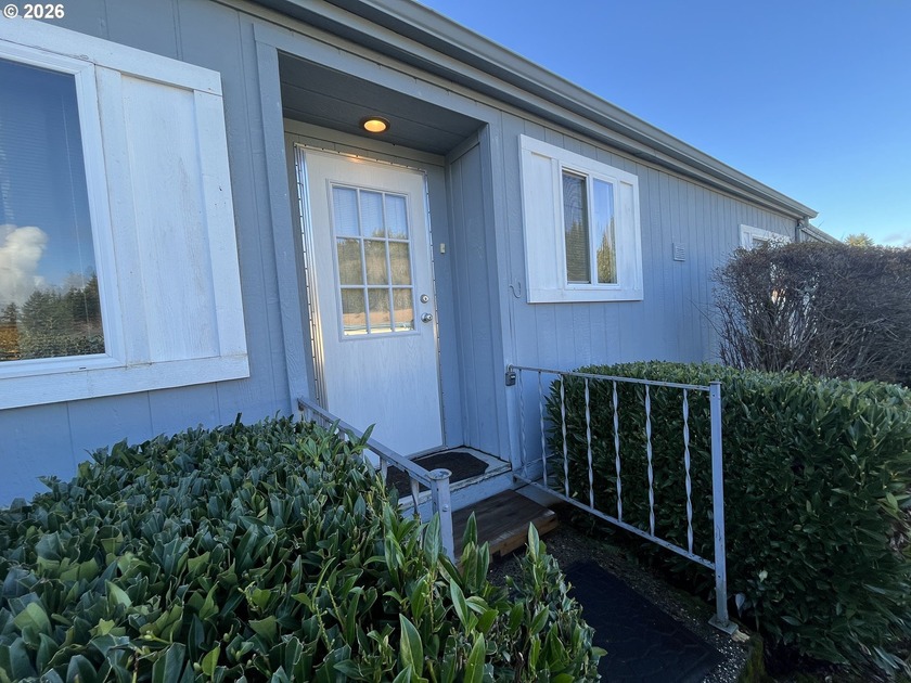 Discover serene waterfront living in this charming doublewide - Beach Home for sale in Reedsport, Oregon on Beachhouse.com