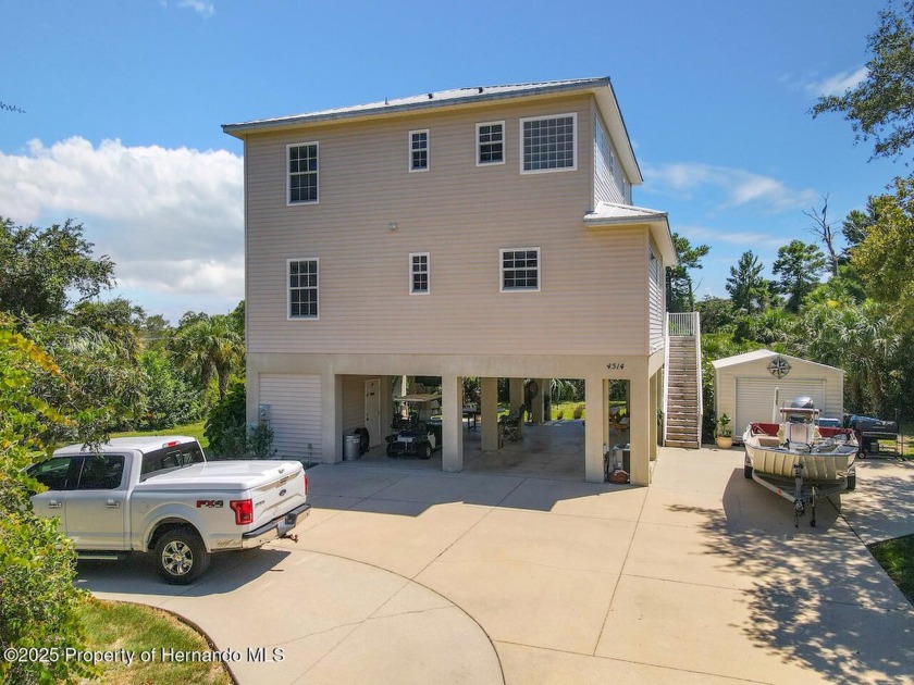 High and Dry! This custom 3 story stilt home is located in - Beach Home for sale in Spring Hill, Florida on Beachhouse.com