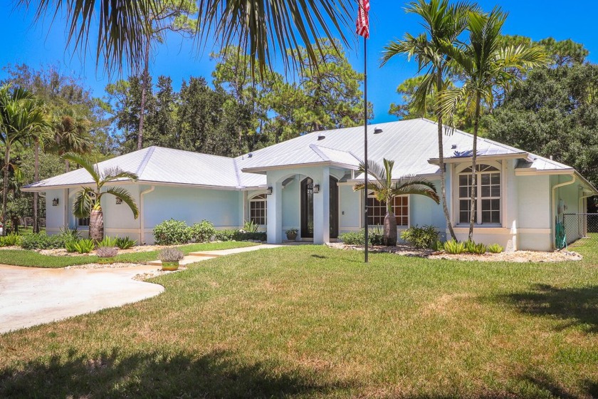 This beautiful ranch-style home features three bedrooms, a bonus - Beach Home for sale in Palm Beach Gardens, Florida on Beachhouse.com