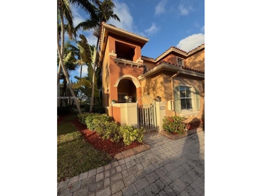 Stunning corner-unit townhome featuring a private patio with a - Beach Townhome/Townhouse for sale in Dania, Florida on Beachhouse.com