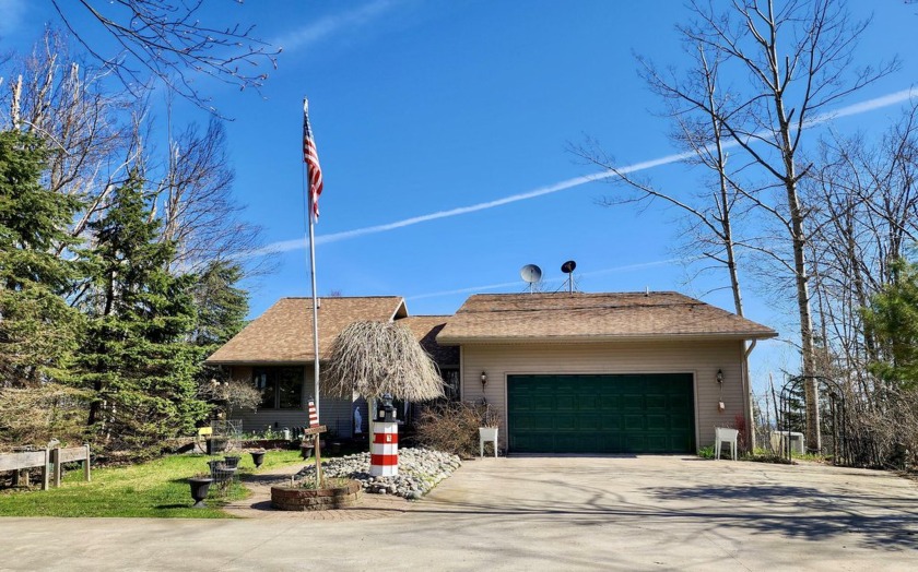 Perched on a bluff overlooking the Straits of Mackinac, this - Beach Home for sale in Cheboygan, Michigan on Beachhouse.com