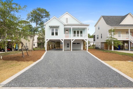 Experience coastal elegance in this stunning 4-bedroom, 3-bath - Beach Home for sale in Oak Island, North Carolina on Beachhouse.com