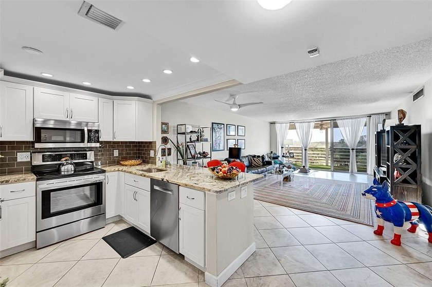 This fully remodeled unit features an open kitchen with white - Beach Condo for sale in Pompano Beach, Florida on Beachhouse.com