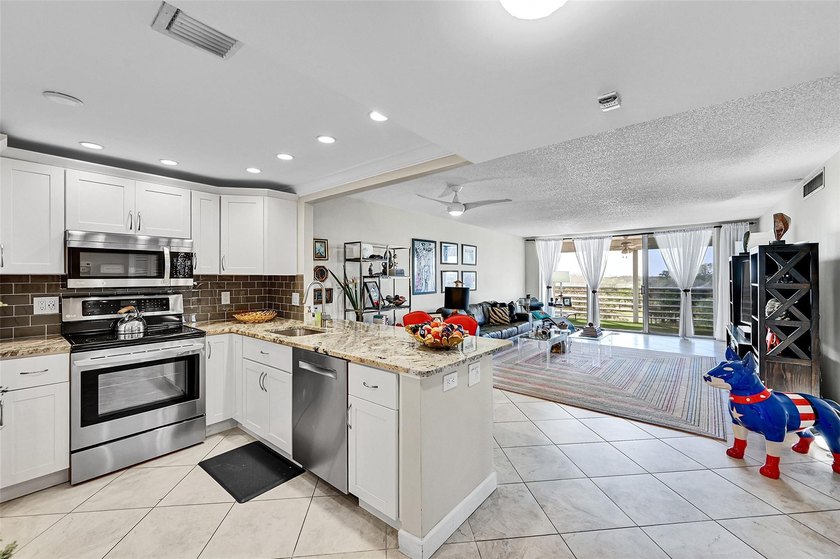 This fully remodeled unit features an open kitchen with white - Beach Condo for sale in Pompano Beach, Florida on Beachhouse.com