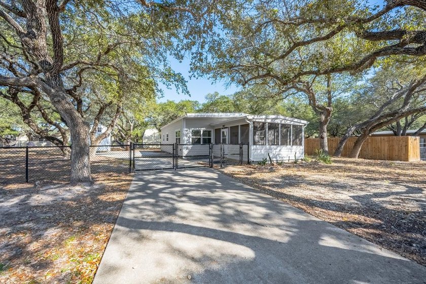 Tucked beneath the shade of towering coastal live oaks, this - Beach Home for sale in Rockport, Texas on Beachhouse.com