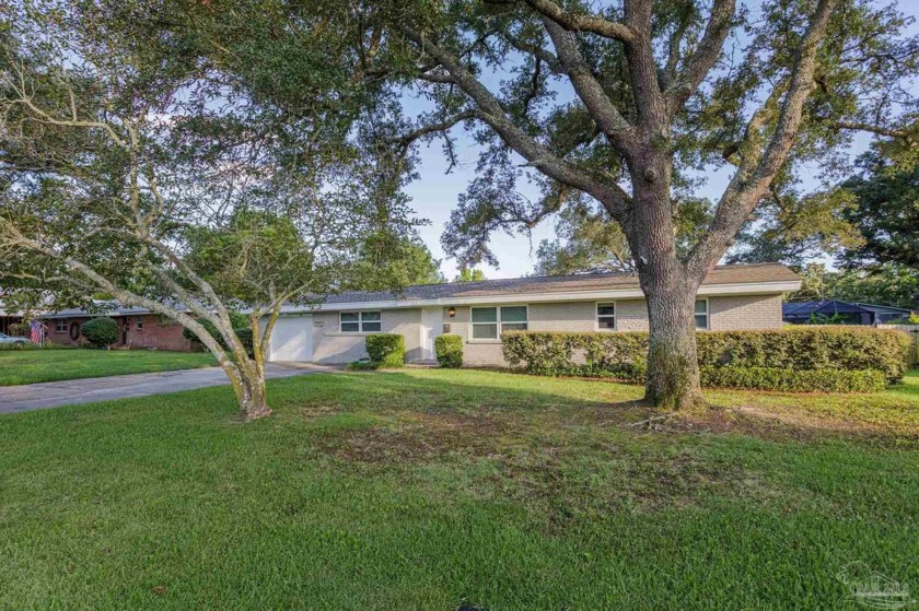 Shaded by mature trees, set back from the road on one of Gulf - Beach Home for sale in Gulf Breeze, Florida on Beachhouse.com