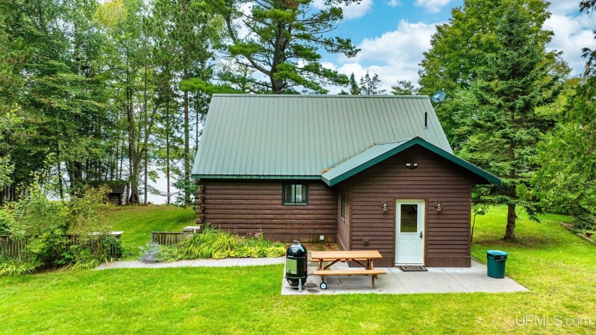 This custom-built 32x26 cedar log cabin, with a beautiful 11x11 - Beach Home for sale in L Anse, Michigan on Beachhouse.com