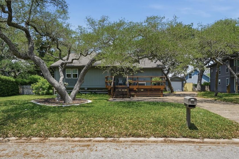 Tucked beneath a canopy of mature oak trees in desirable Harbor - Beach Home for sale in Rockport, Texas on Beachhouse.com